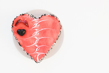 Valentines Day heart shaped cake with chocolate and strawberries on plate, white background. Festive dessert for date, anniversaries and party concept. Close up, copy space