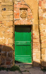 A door in an old residential buildings in the historic centre of the medieval town of Monticchiello near Pienza in Siena Province, Tuscany, Italy
