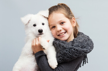 smiling girl and white puppy