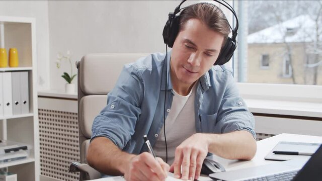 Workplace of freelance worker or sudent at home office. Young man works using computer. Remote job concept.