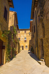 Fototapeta na wymiar Historic residential buildings in a the centre of the medieval town of Monticchiello near Pienza in Siena Province, Tuscany, Italy 