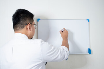 Businessman writing in a whiteboard