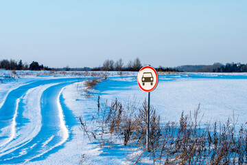 No cars sign on winter field road