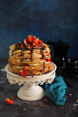 Chocolate, strawberry and hazelnut Crepe Cake in rustic style. Space for text or recipe. Selective focus.