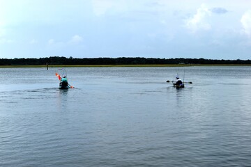 Fototapeta na wymiar Fishermen kayaking on the river at Florida, USA