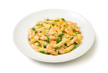 Fototapeta na wymiar Pasta with shrimps, leeks and spinach in a white plate, Isolated on white background. Close-up. 