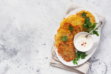 Fried potato pancakes on the old wooden background. Traditional Belarusian dish. Top view.