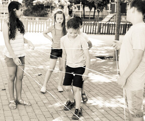 active children games. boy gently passes through the tangled rope