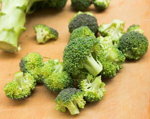 resh appetizing broccoli inflorescences on wooden board