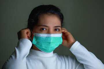 Portrait of a woman wearing an Anaamai mask To prevent germs On black background