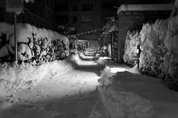 Alley with layer of fresh snow in the morning. City of Zurich, Switzerland.