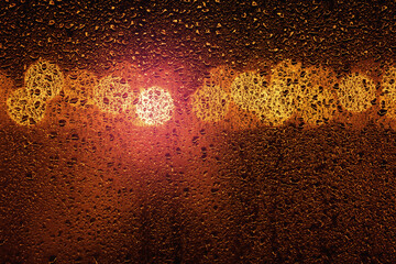 Rain on a window with big city bokeh lights