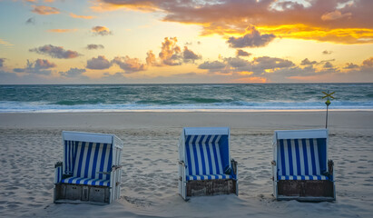 Fototapeta na wymiar beach chairs on the beach at sunset
