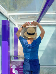 Woman sanitizing herself before going to the shopping mall at the sanitizing or decontamination tunnel