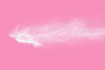 White powder explosion on pink background.