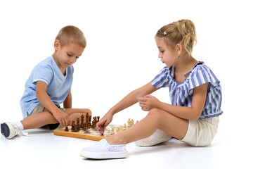 Boy and girl playing chess board game