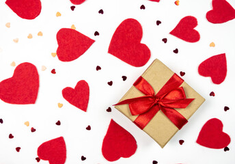 Gift and red hearts on a light background.Valentine's Day.