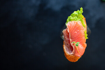 sandwich salmon fish bruschetta with seafood antipasto aperitif ready to eat on the table for...