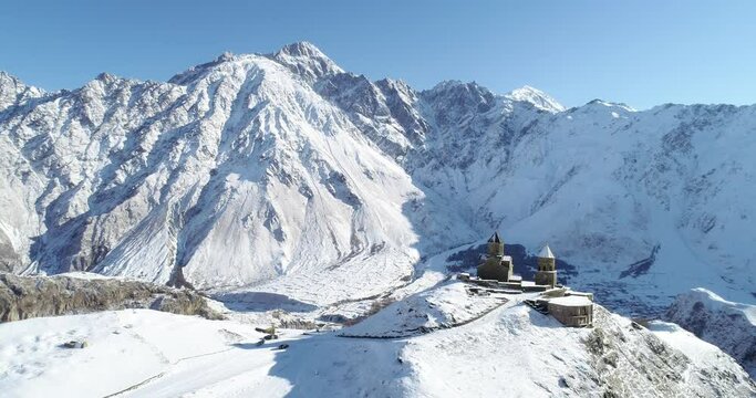 Holly Trinity church in stephantsminda, Gergeti in Republic of Georgia. Kazbegi glacier near the church