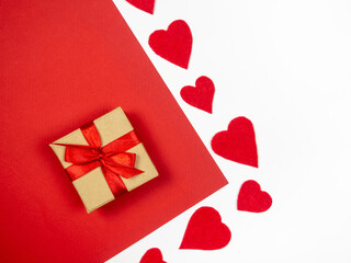 Gift and red hearts on a red and white background.Valentine's Day.