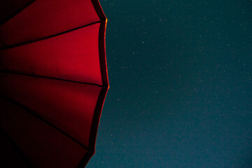 parasol under dark sky with stars