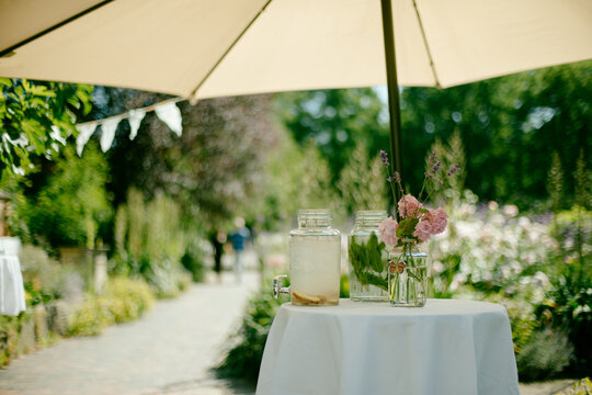 Lemon Drink On Table In Garden Under Parasol