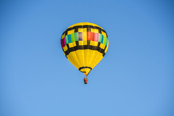I captired this image one morning this past fall. You can see how the sky would change color as I took pictures from different angles, Hot air balloon floating free.