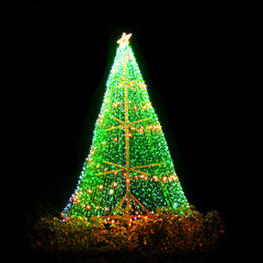 Christmas tree with bright green lights,On a black background.