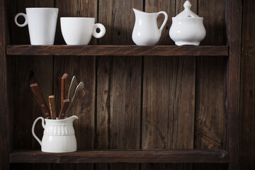 white kitchen dishware on old dark wooden background
