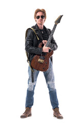 Naklejka premium Macho stylish rocker with electric guitar and sunglasses wearing leather jacket and jeans. Full body isolated on white background. 