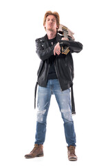 Fototapeta premium Cocky attitude macho rocker in leather jacket carrying electric guitar staring at camera with head back. Full body isolated on white background. 