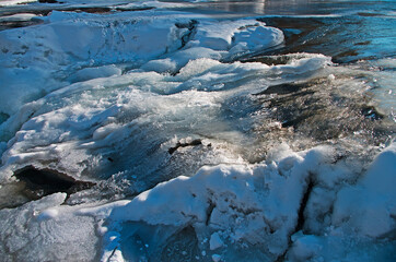 Mountain clear melt water in the river during the winter thaw or spring warming.