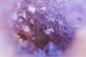Abstract blurred background with shiny purple amethyst crystal geode , full frame with selective focus on various points