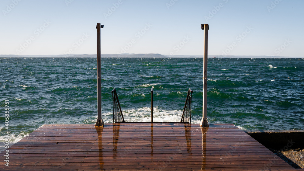 Wall mural wooden pier with sea background