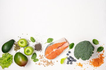 Set of food for healthy diet. Salmon, legumes, chia seeds, vegetables and fruits on white background. Food background with empty space