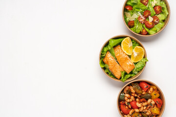 Paper containers with healthy takeaway food. Salmon, lettuce and bell peppers with beans. Food delivery concept