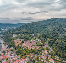 Obraz premium Aerial drone shot of Heidelberg old town in overcast summer at foot of Konigstuhl mountain