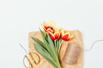 Bunch of fresh tulips in brown eco paper