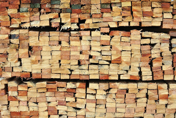 Wood that has been processed and cut, neatly arranged to form an interesting pattern.