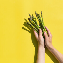 Asparagus with trendy hard light and shadows yellow background