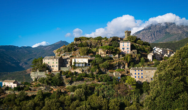 The village Nonza, located both the side of a cliff, Cap Corse, Corsica, France. Tower (Tour Paoline) on top of the cliff