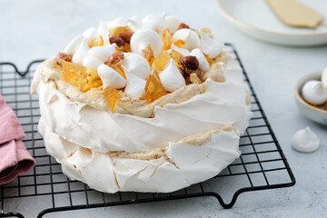 Pavlova cake with caramel and nuts on the white background.