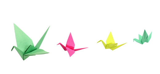A green origami crane flying on white