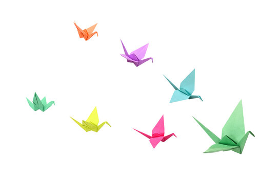 A green origami crane flying on white