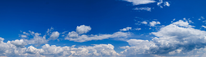 Naklejka na ściany i meble Blue sky with clouds in sunlight, wide cloudscape background panorama