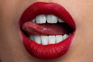 Sexy red lips of young woman close-up. Red lips make up. 