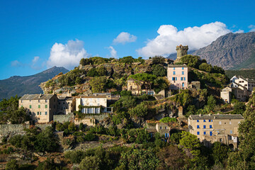 The village Nonza, located both the side of a cliff, Cap Corse, Corsica, France. Tower (Tour Paoline) on top of the cliff