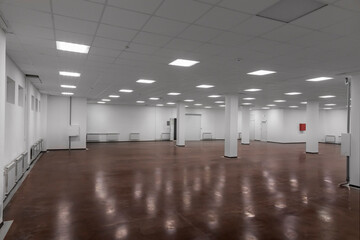Empty light commercial space. Premises for rent. An empty room with large white walls.