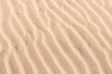Fototapeta na wymiar Wavy sand close up. Perfect photography for a wallpaper use. Summer atmosphere.