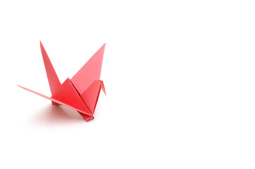 A red origami bird on white